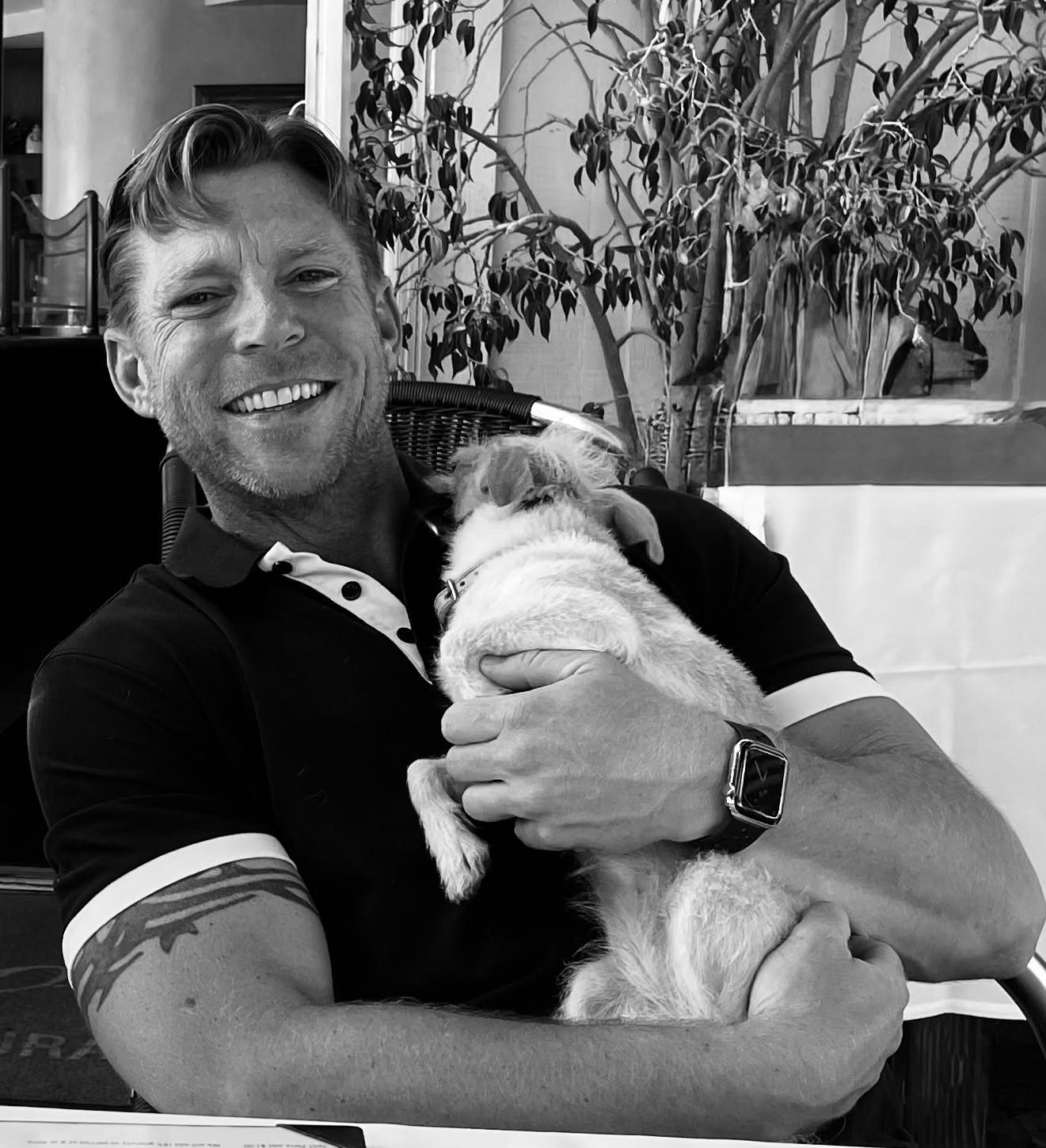 Brook Church-Koegel smiling, holding his dog